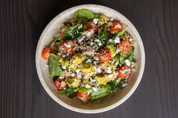 Close-up of a vibrant and nutritious salad made with quinoa, avocado, mixed seeds, and cheese, packed with protein and healthy fats for a wholesome meal