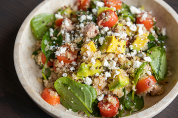 Close-up of a vibrant and nutritious salad made with quinoa, avocado, mixed seeds, and cheese, packed with protein and healthy fats for a wholesome meal