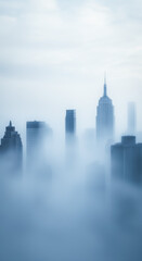 Obraz premium Ethereal New York City skyline cloaked in fog, with iconic skyscrapers and a peaceful, otherworldly atmosphere that captures the essence of urban beauty.
