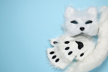 Quadrobics. Cat mask, tail and gloves on light blue background, top view. Space for text