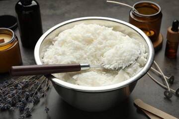 Soy wax and other supplies for making candles on grey table, closeup