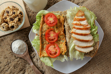 Big breakfast, bread, chicken slice, tomato, lettuce, smoked beef, egg, salad with milk. Bread sandwich fresh and healthy food meal lunch dinner breakfast slices of sandwiches.