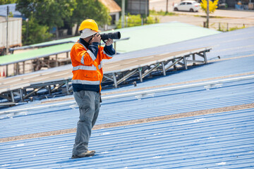 professional camera man working in dangerous workplace photograph at industry workplace outdoors
