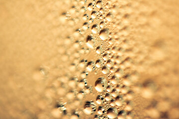 Close Up of Water Droplets Liquid Bubbles Abstract Background in Gentle Gold Orange
