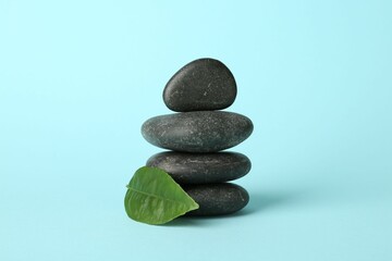 Stack of rocks on light blue background. Harmony and life balance