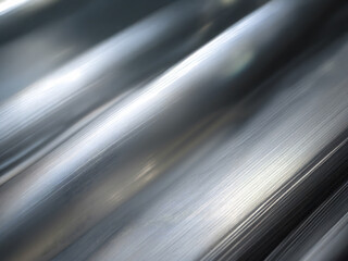 Smooth metallic texture with reflective surface under natural light creating an abstract effect