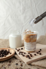 Delicious iced coffee, mocca, and chocolate drinks with coffee beans on white wooden table