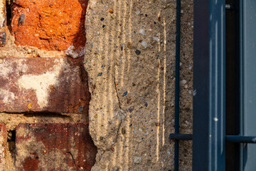 Textured wall with brick and concrete elements showcasing unique patterns of light and shadow