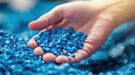 Close Up of Hand Holding Blue Plastic Granules