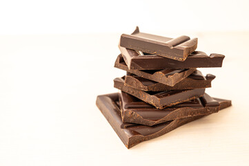 Chocolate chips stacked on white surface