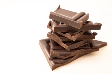 Chocolate chips stacked on white surface