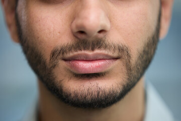 Obraz premium young beautiful man with brown eyes looks at the camera.