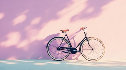 Fototapeta premium A stylish shot of a black vintage bicycle with leather handles, parked against a pastel lilac wall under subtle light