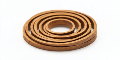 Natural wooden incense coil set in graduated sizes arranged in concentric circles on a clean white background showcasing warm brown tones.