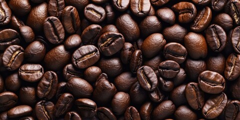 Naklejka premium Close-up of dark roasted coffee beans arranged tightly in a rich brown textured background with varied shades and natural shine for depth.