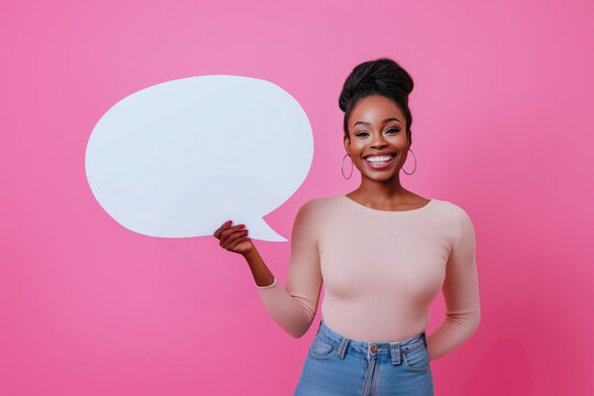Beautiful african american woman holding a blank white paper in shape of speech bubble and smiling