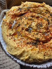 Sweet potato hummus or pumpkin dip with smoked paprika, olive oil, whole chickpeas close up. Healthy vegan food. 