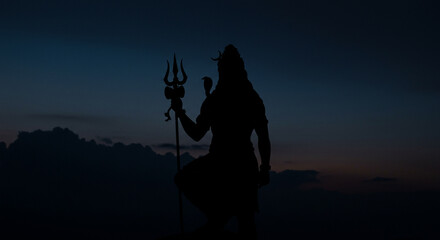 Fototapeta premium Lord Shiva Holding Trident in Twilight Silhouette