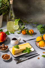 Gourmet cheese platter with fruits, nuts, and limoncello liqueur enhancing culinary experience