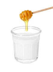 Honey dripping from dipper into glass of milk on white background