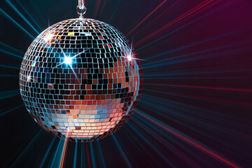 Disco ball reflecting light on dark background. Nightclub decor