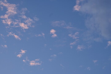 pink and grey clouds against the blue sky 