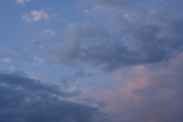 pink and grey clouds against the blue sky 