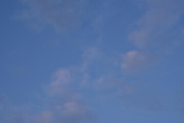 pink and grey clouds against the blue sky 