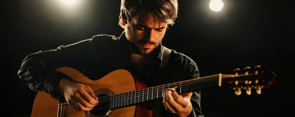 Obraz premium Young musician playing the guitar on stage under spotlight, passionate performance.