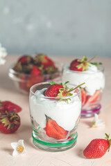 Delicious strawberries with cream cheese dessert in glasses