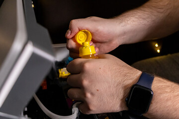 opening yellow ink bottle during printer refill process with a focus on preparation for tank filling