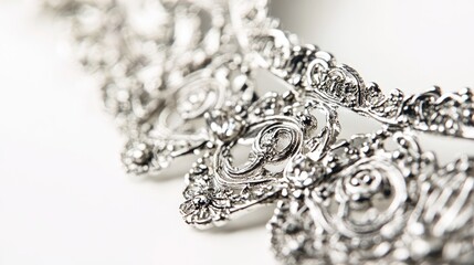 Obraz premium Elegant silver designer costume jewelry captured in macro photography showcasing intricate details on a clean white background