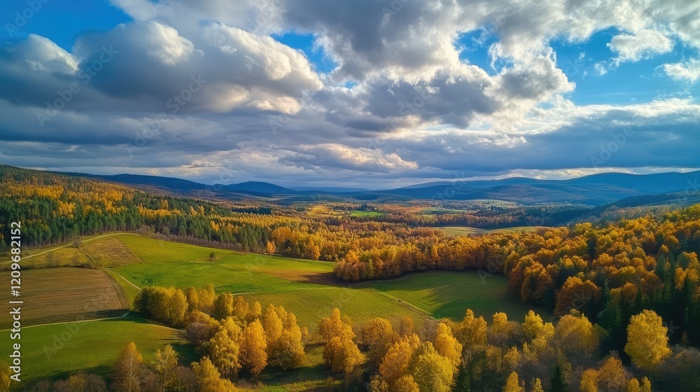 Poster expansive aerial view of vibrant autumn foliage in rolling hills under a blue sky with fluffy clouds