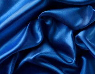 Fototapeta premium Dark blue silk satin background. Bright folds on a shiny fabric