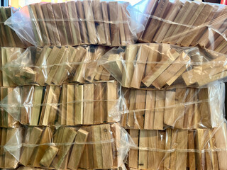 Birch firewood in a net for sale. Wooden logs for kindling
