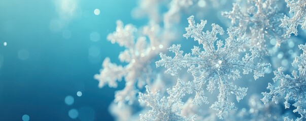Abstract snowflakes on a gradient blue background, winter-themed design.