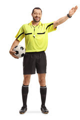 Football referee holding a ball and pointing with hand