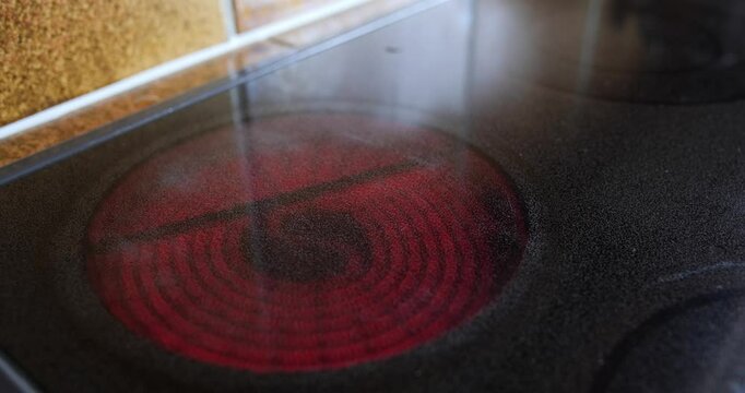 Electric or induction stove being turned on. Glowing red-hot plate, close up shot, real time, no people