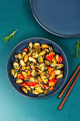 Fried mussels without shell with vegetables.