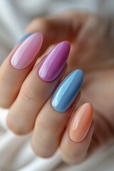 A girl hand with a fresh manicure in soft pastel colors. Focus on five perfectly styled nails on a light, textured background.