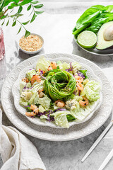 salad with shrimp, cheese and avocado on a marble background