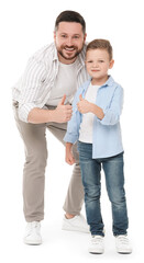 Happy father with his cute little son showing thumbs up on white background