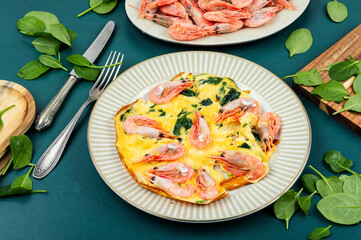 Appetizing omelette with seafood and greens.