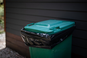 green garbage bin waste collection bag
