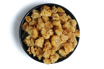 A small portion of fried corn nuts isolated on a white background.