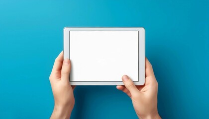 hands holding digital tablet with a white blank screen
