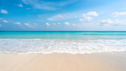 Obraz premium The vast ocean meets the sandy beach under a vibrant blue sky, creating a picturesque tropical seascape perfect for summer vacations