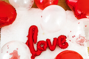 Valentines flat lay. Stylish red love shaped balloon on soft white background. Happy valentines...