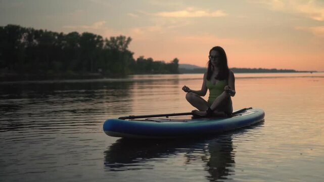 peaceful and serene scene shows a woman meditating