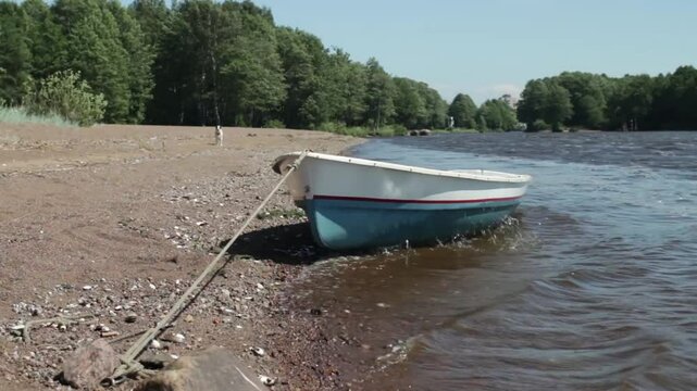rowing boat tied to the shore with a rope, river